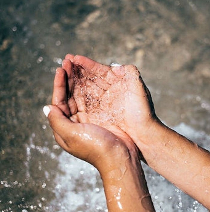 Hands holding water